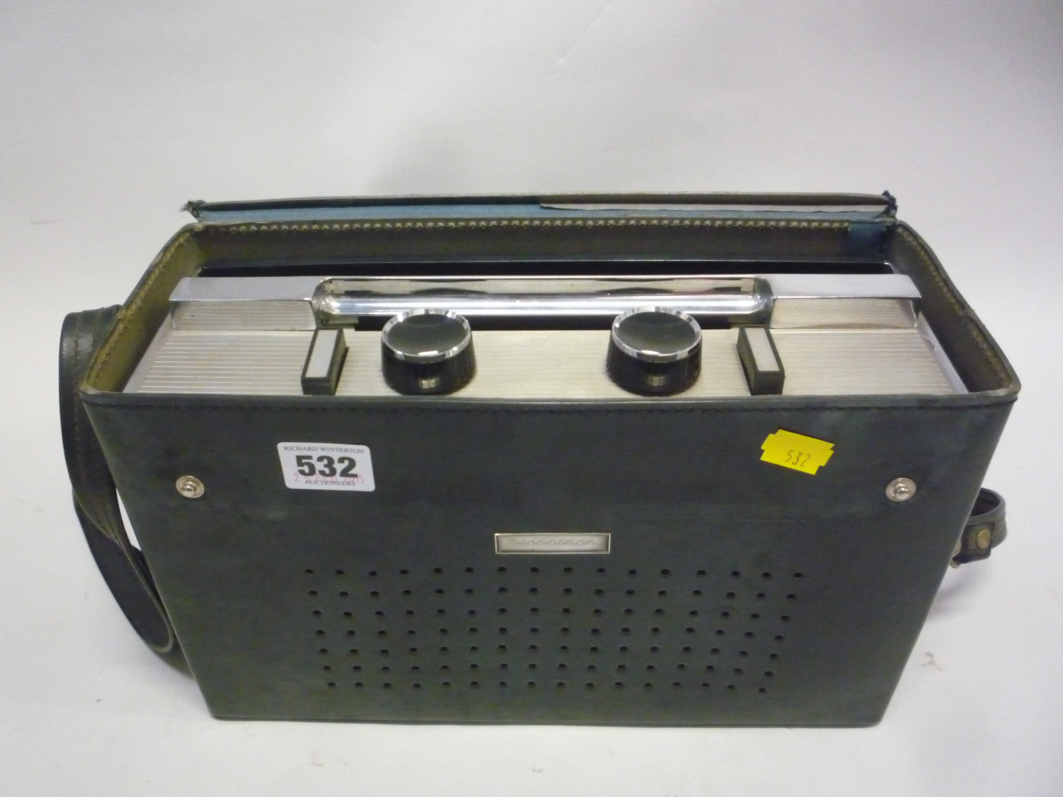 A DISCATRON PORTABLE 7' RECORD PLAYER, pressed chromium and plastic