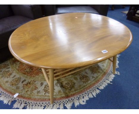 AN ERCOL BLONDE OVAL COFFEE TABLE, with spindle undershelf