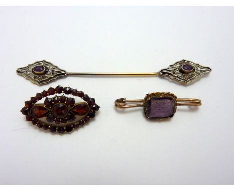 THREE ITEMS, to include a cloak pin, a garnet brooch and an inscribed amethyst seal brooch