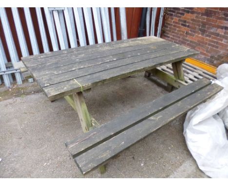 A LARGE WOODEN PICNIC BENCH
