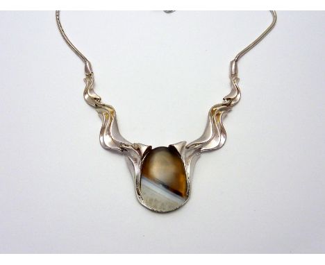 A NECKLACE, with central chalcedony stone and white metal abstract shaped flanked links