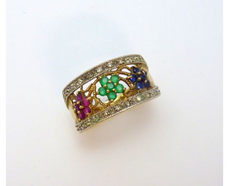 A 9CT GOLD DRESS RING, designed as three flowers within diamond boarders, to include emerald, sapphire and rubies, hallmarks 