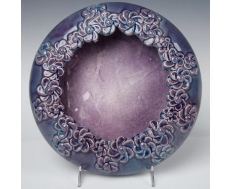 Vintage planter bowl showcasing raised relief daisies against a smooth ceramic background, glazed in a stunning purple hue wi