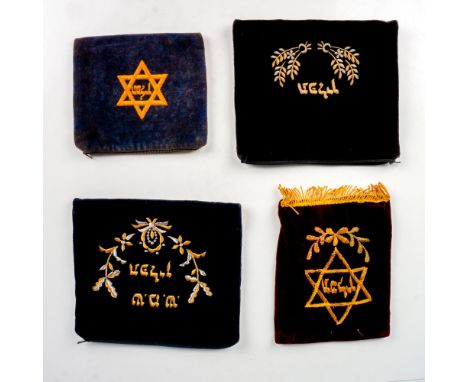 Set of four velvet tefillin pouches. Each has embroidered Hebrew text, which reads Tefillin and exhibits either Stars of Davi