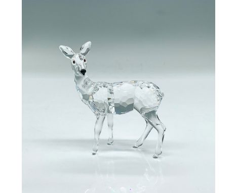 Clear faceted crystal figure of a standing young deer in an alert pose. Swarovski mark. Part of the Rare Encounters collectio