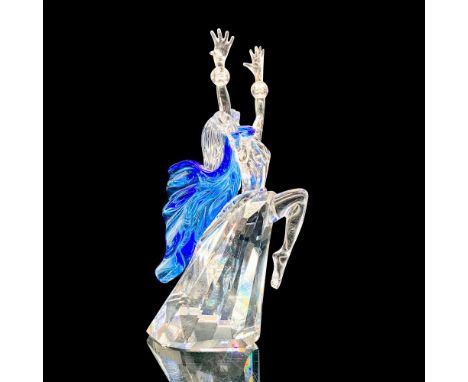 A clear crystal figurine of Isadora Duncan in a mid-dance pose with her arm raised while a blue crystal scarf envelops her. S