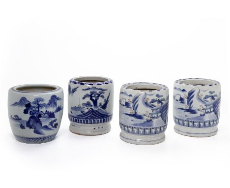 FOUR BLUE AND WHITE JAPANESE CERAMIC PLANTERS
Three of similar form and decorated with pagodas and mountainous landscape scen