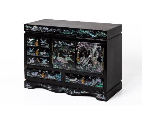 A KOREAN BLACK LACQUERED SMALL CABINET
The interior fitted with two cupboard doors with three short drawers and two long bene