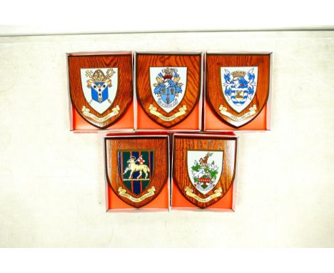 A collection of boxed wooden heraldic shields each with hand painted raised shield, including Stevenage, Archbishop Canterbur