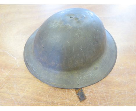 Mark 1 WW1 Brodie Helmet. A rimmed version by Hadfield Ltd of Sheffield. Good original condition with oilskin liner. Chinstra