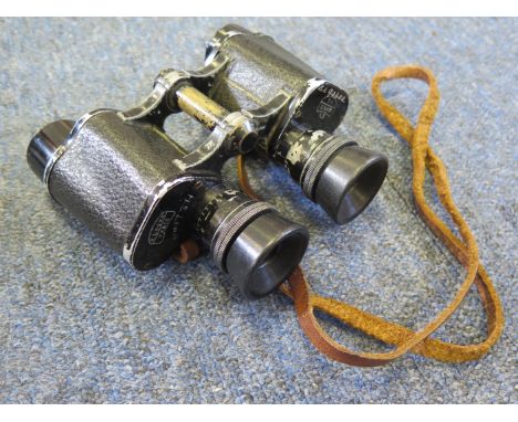 An attributed pair of military issue Prismatic Binoculars x8 in its leather case. Maker E. Leger. Paris. W/D marked. Binocula