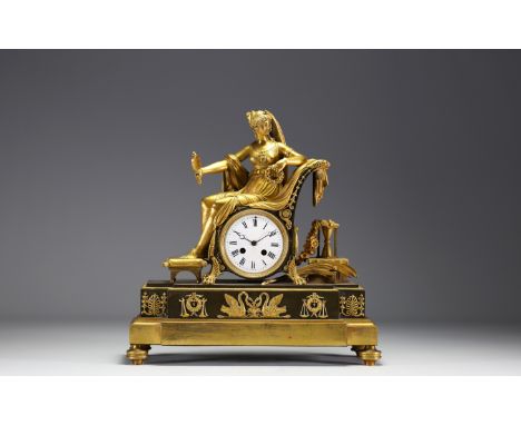 Double patinated gilt bronze and chased 1st Empire mantel clock representing a draped woman holding a mirror seated in an arm