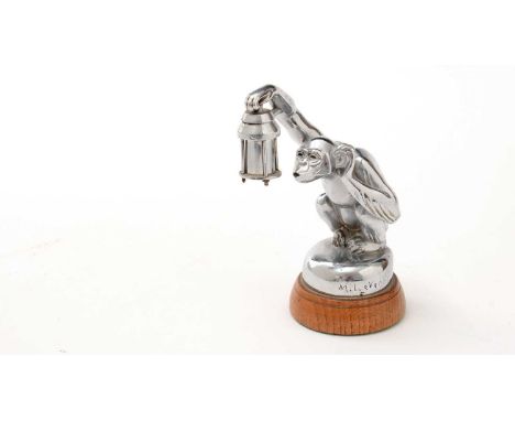 Max Le Verrier chrome Boubou car mascot, circa 1925, in the form of a monkey holding a lamp, signed and stamped 'France, on w