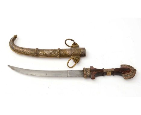 An early 20th Century Persian Khanjar, the 23cms curved double-edged blade on carved-shaped wooden hilt with brass mounts, fi