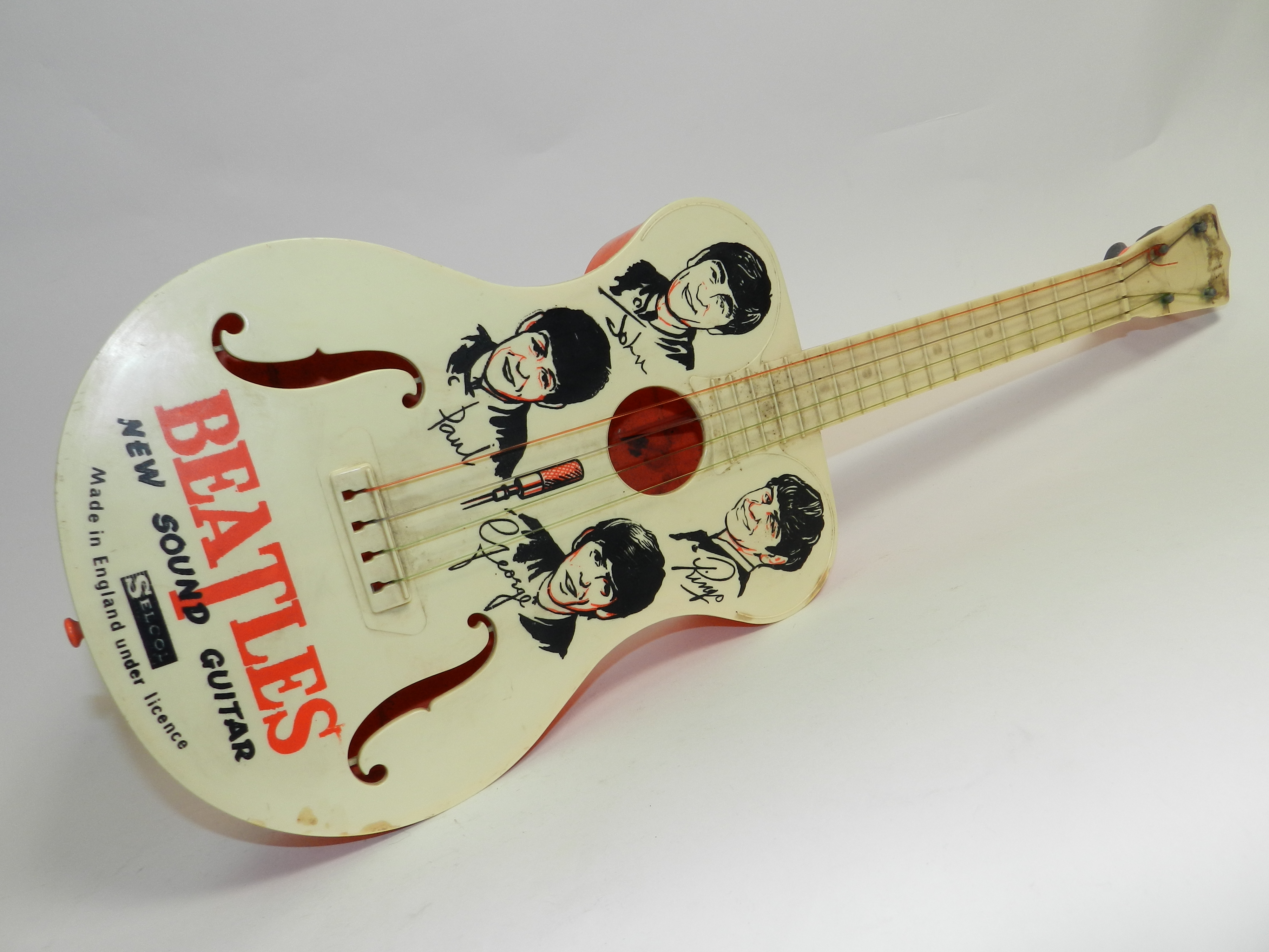 A Beatles Toy Guitar By Selco Circa 1964 Fitted With Original Strings And With Intact Body Deco