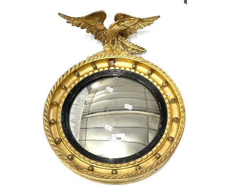 Georgian style porthole mirror in a circular gilt finish frame with eagle mount, 43cm diameter