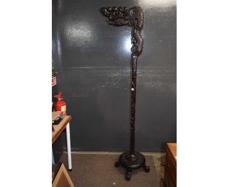 A 20th Century Chinese hardwood dragon formed standard lamp, lacking any electrical fittings, 185cm high