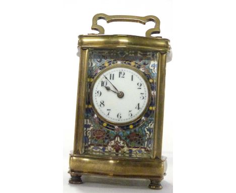 A 20th century brass cased carriage clock with unsigned coloured enamel decorated face .- 15 cm high including handles