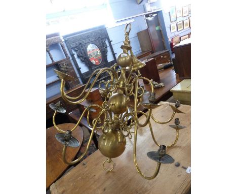 A large reproduction Dutch style brass light fitting, fitted with twelve scrolled arms, approx 95cm high