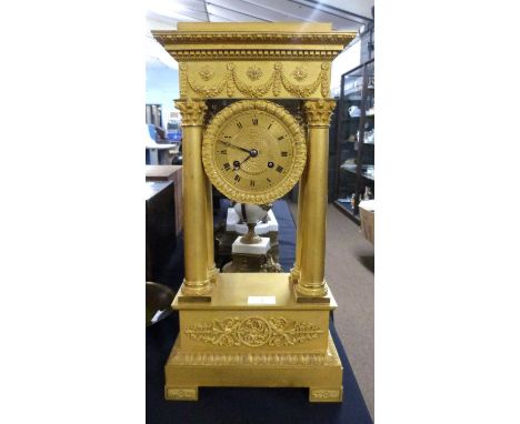A French Empire style gilt mantel clock with four Corinthian columns, the dial signed Piecour a Bourges