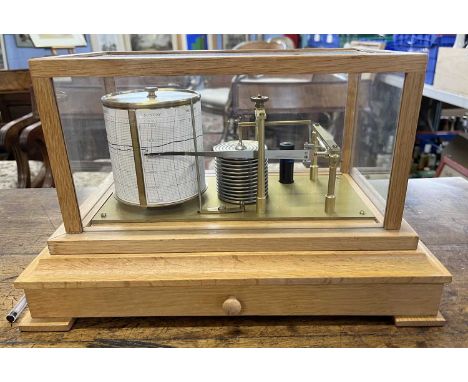 Early 20th Century barograph set in a light oak case with base drawerThe clockwork eight-day movement is housed in the drum, 