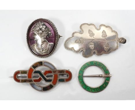 FOUR SILVER BROOCHEScomprising a hardstone set unmarked silver brooch of entwined form; a green enamel decorated silver annul