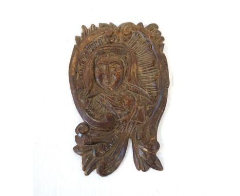 18th CENTURY CARVED WOODEN WALL PLAQUEdepicting a religious figure within a floral scroll surround, 30cm high