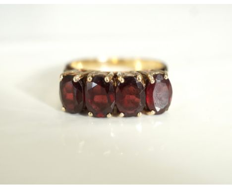 GARNET FOUR STONE RINGthe four oval cut garnets on nine carat gold shank, ring size M-N