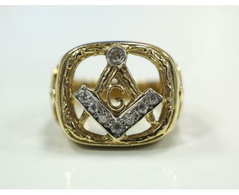 MASONIC NINE CARAT GOLD AND GEM SET RING with pierced compass decoration flanked by pierced shoulders, ring size L