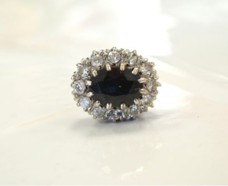 SINGLE SAPPHIRE AND DIAMOND CLUSTER EARRINGthe central oval cut sapphire in twelve diamond surround, in eighteen carat gold