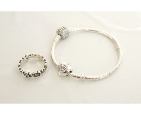 PANDORA SILVER CHARM BRACELET
with a heart shaped charm; together with a CZ set Pandora silver ring with flower head decorati
