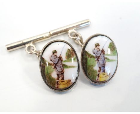 PAIR OF SILVER AND ENAMEL FISHING CUFFLINKSeach of the oval enamel panels depicting a fisherman on the riverbank, in box