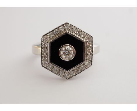 ATTRACTIVE ART DECO STYLE DIAMOND AND ONYX RINGthe central round brilliant cut diamond approximately 0.25cts, an a hexagonal 