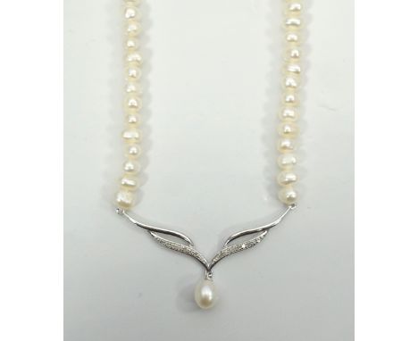 CULTURED PEARL AND DIAMOND NECKLETthe front nine carat gold pendant section set with diamonds and a pearl drop, with attached