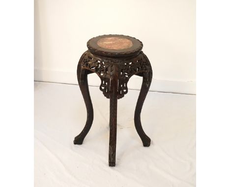 CHINESE HARDWOOD STANDwith a circular top and an inset red veined marble panel above a carved and pierced frieze with floral 