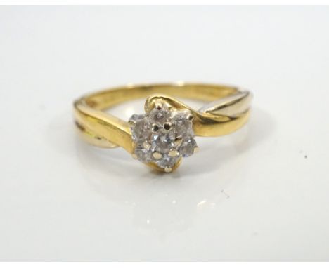 DIAMOND CLUSTER RINGthe diamonds totalling approximately 0.25cts, on eighteen carat gold shank with twist shoulders, ring siz