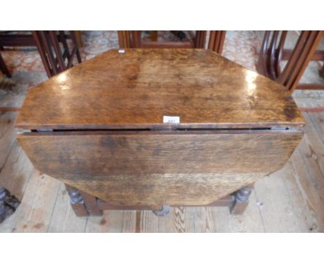 A 1930's oak octagonal gate leg occasional table, 70cm diameter.