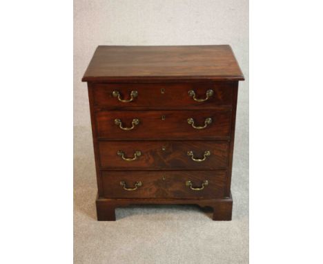 A George III mahogany bachelors chest of four long graduated drawers with brass swing handles on shaped bracket feet. H.80 W.