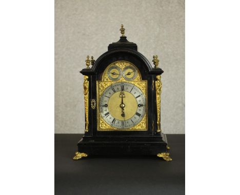 A late 19th Century George III style ebonised cased bracket clock, the arch dial incorporating a silvered chapter ring with R