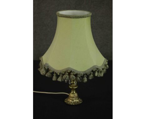 A brass table lamp, hung with faceted glass lustres on a cast feather base, with a pale green shade. H.48 w.30cm. 