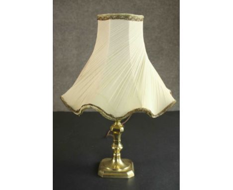 A brass table lamp converted from a candlestick, with a cream coloured shade. H.44 Dia.30cm. 