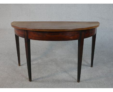 A George III mahogany demi-lune console table on square section tapering legs. H.74 W.129 D.64cm 