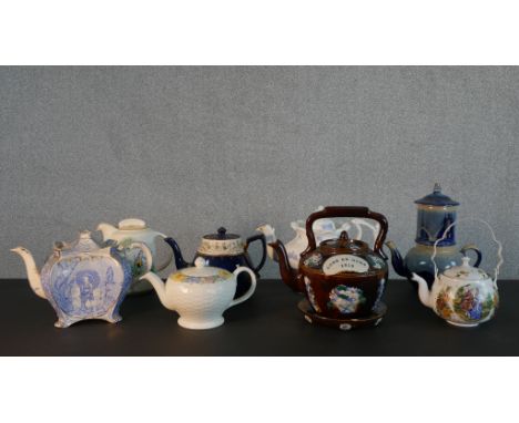 A collection of eight 19th and 20th century tea pots, including a barge ware ceramic tea pot and stand, a two tired art potte