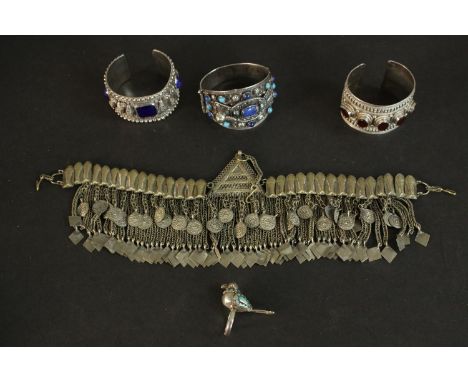 A Kuchi Afghan tribal headdress, an Afghan ring in the form of a bird with inlaid turquoise feathers along with three Afghan 
