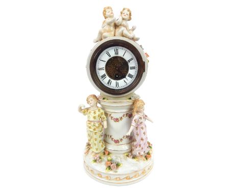 A late 19th century German porcelain figural mantle clock, in the Augustus Rex style, on drum head cylindrical column,  the e