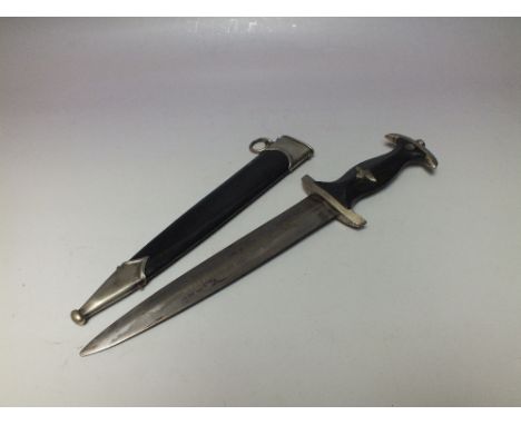 A NAZI STYLE S.S. DAGGER IN BLACK SCABBARD, with indistinct inscription on blade L 21 cm, overall L 38 cm