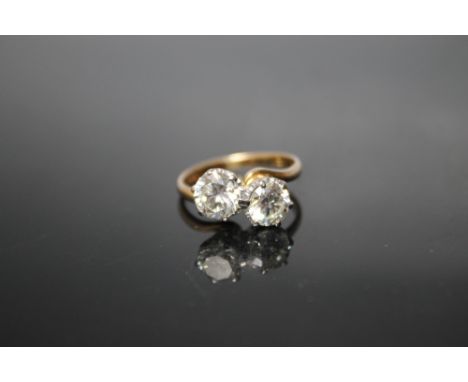 A BRILLIANT CUT DIAMOND TWO STONE RING, coming with a Anchor Cert certificate commissioned by Cuttlestones stating the larger
