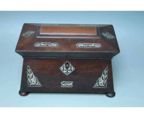 A 19TH CENTURY ROSEWOOD AND MOTHER OF PEARL INLAID TEA CADDY, of typical sarcophagus form, twin lidded compartments to the in