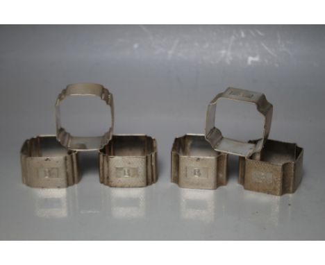 SIX HALLMARKED SILVER NAPKIN RINGS, consisting of two sets of three shaped napkin rings with engine turned design and all eng