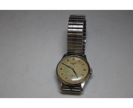 A GENTLEMANS LONGINES WRISTWATCH WITH ENGRAVED DEDICATION TO REVERSE DATED 1955, the circular dial marked 'Longines, Pidduck 